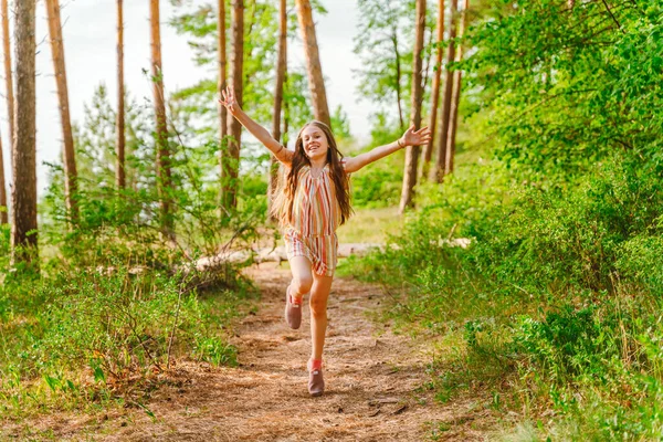 Mała Dziewczynka Biegnie Szczęśliwie Otwartymi Ramionami Ścieżce Lesie — Zdjęcie stockowe