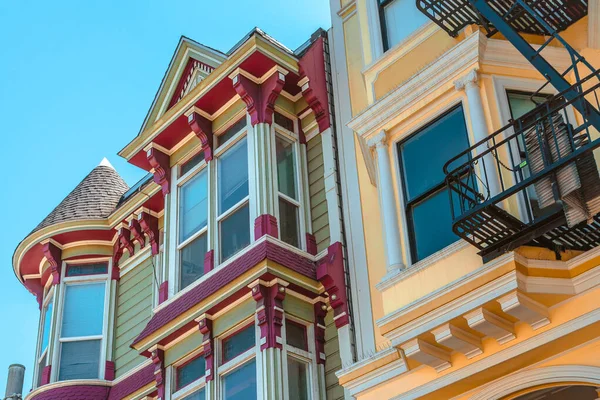 Facades of townhouses with famous Victorian architecture, streets in San Francisco