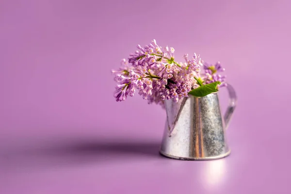 A beautiful spring bouquet of lilacs in a vase, a beautiful floral composition. Minimalistic background