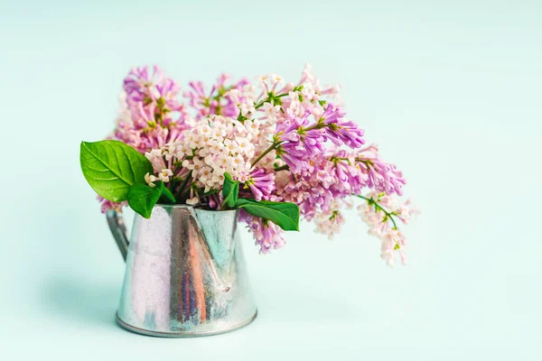 A beautiful spring bouquet of lilacs in a vase, a beautiful floral composition. Minimalistic background
