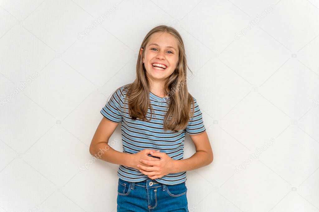  Portrait of a smiling little girl child with long blonde hair on a white background