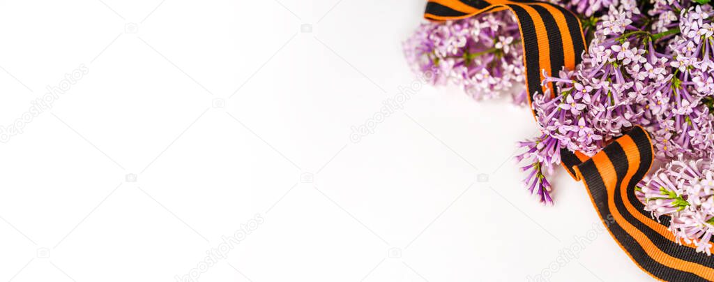Beautiful floral background with St. George ribbon and lilac. Spring holiday banner with a place for the text