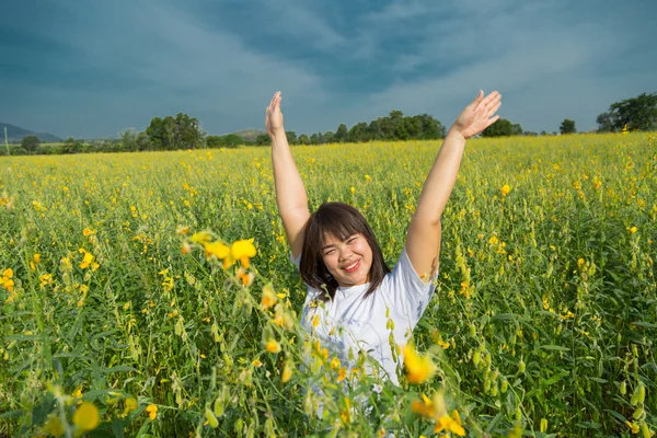 Asian young  chubby women is raising arms to the sky in yellow f Stock Photo