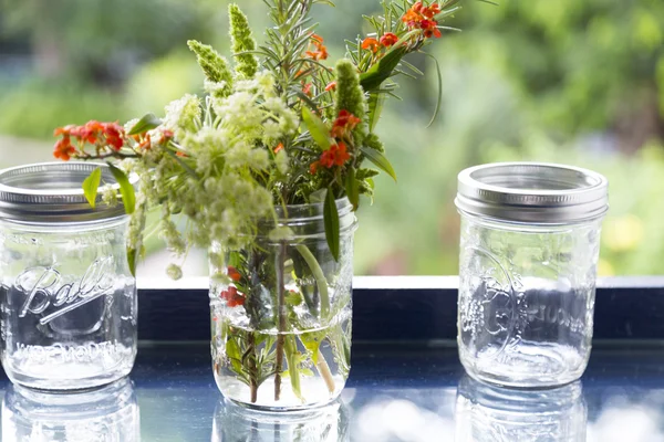 Flowers in glass jar with bokeh background — Stock Photo, Image