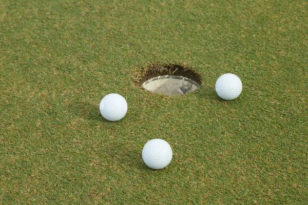 3 white golf on green — Stock Photo, Image