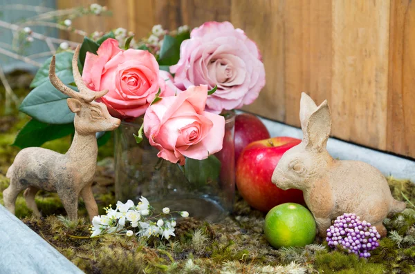 Still life with pink of rose beside Rabbit and deer ceramic plas — Stock Photo, Image