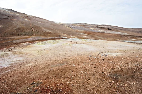 Hverir geothermal area in North of Iceland, volcano mud and cracked red ground Royalty Free Stock Photos