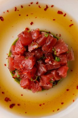 Avokado püresi soslu somon dilimli bir tabağın yakından görüntüsü.