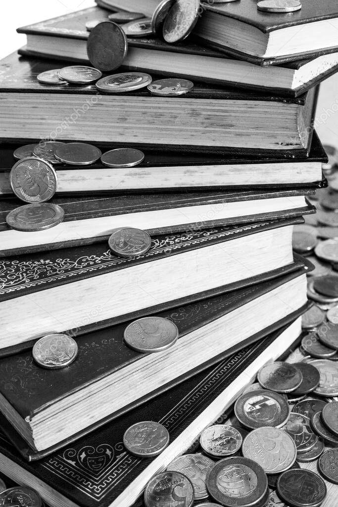 Pile of books surrounded by many different coins (Black and White version)