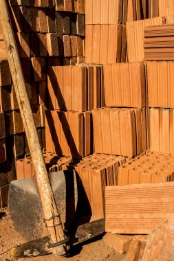 Bir kürek ve çapa blokların ve tuğlaların yanında.