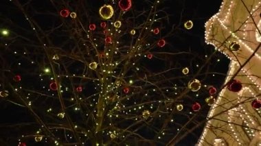 Alacakaranlıkta şehir tatil manzarası. Binanın ön cephesi Noel süsleriyle süslenmiş güzel bir mimariyle. Doli kamera görüntüsü