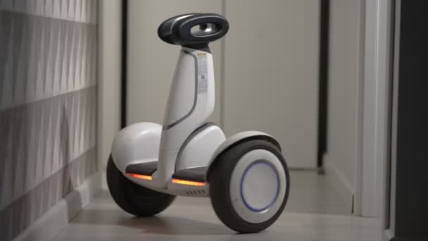 Branco moderno gyro scooter gadget equilibra-se e gira sem inteligência na sala e atinge as paredes — Vídeo de Stock