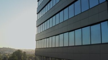 windows of empty offices of modern mirrored business center during covid-19 pandemic isolation. window view of the deserted floors of a mirrored office building