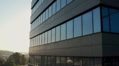 windows of empty offices of modern mirrored business center during covid-19 pandemic isolation. window view of the deserted floors of a mirrored office building
