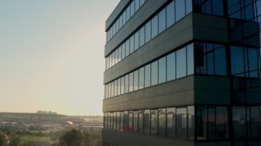 windows of empty offices of modern mirrored business center during covid-19 pandemic isolation. window view of the deserted floors of a mirrored office building