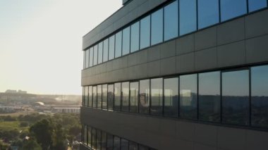 windows of empty offices of modern mirrored business center during covid-19 pandemic isolation. window view of the deserted floors of a mirrored office building