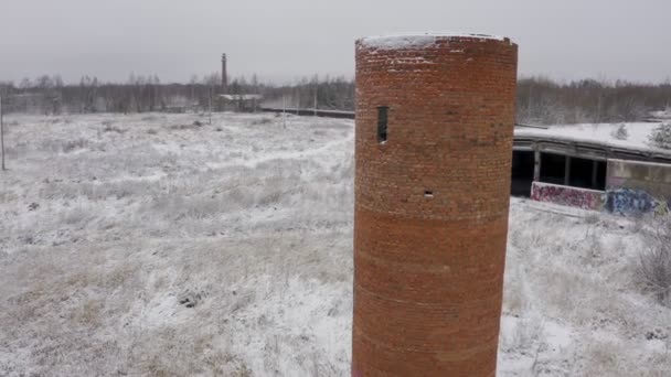 Un edificio abbandonato dai tempi dell'URSS in inverno su un luogo ricoperto di vegetazione. paesaggio strano — Video Stock