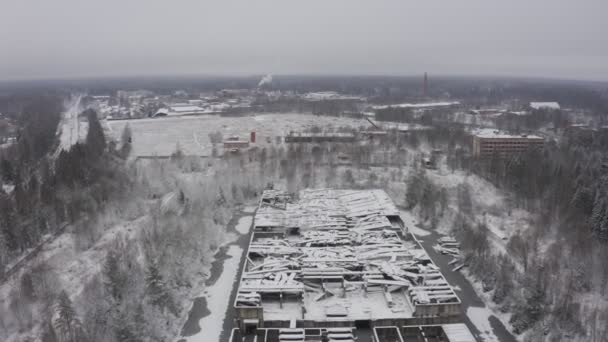 A destroyed building as after the war, in the middle of a forest landscape in winter. aerial view. ruins in winter — Stock Video