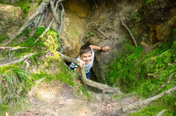Boy climbs from catacombs — Stock Photo, Image