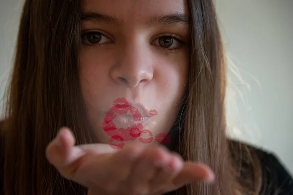 young woman blowing a kiss with red lips coming out of mouth ,valentines day kiss with social distancing.