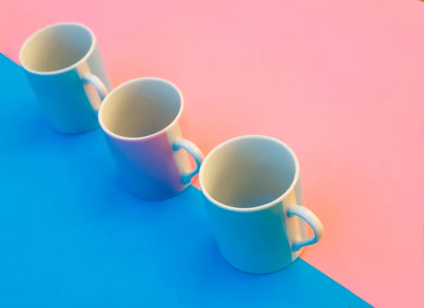 Pink and blue coffee cups on coloured background ,graphic image with bright colours.