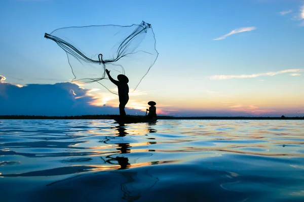 Fisherman fishing during sunset — Stock Photo, Image