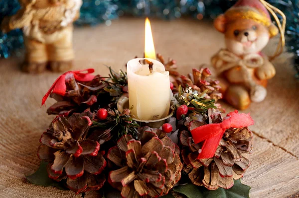 Wax candle on a support from cones — Stock Photo, Image