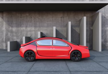 Beton mimari önünde kırmızı elektrikli otomobil