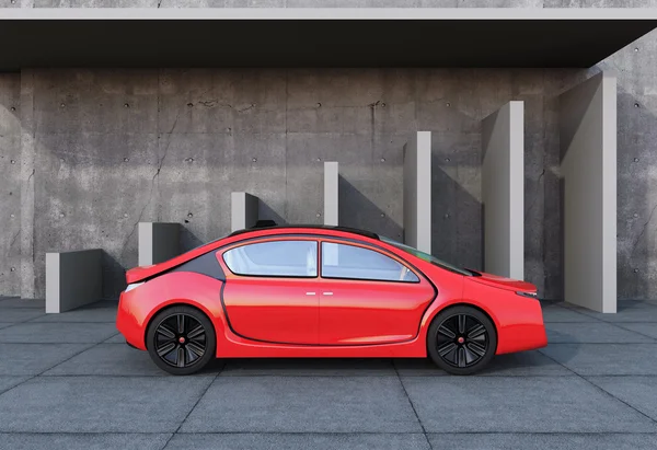 Carro elétrico vermelho na frente da arquitetura de concreto — Fotografia de Stock