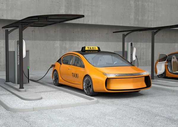 Yellow electric taxi charging in charging station — Stok Foto