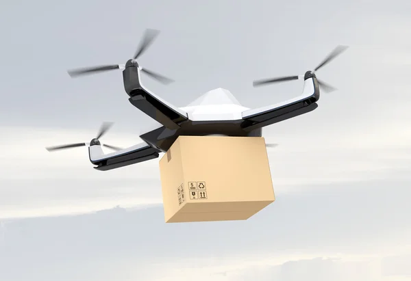 Autonomous unmanned drone delivering cardboard box in the sky — Stock Photo, Image