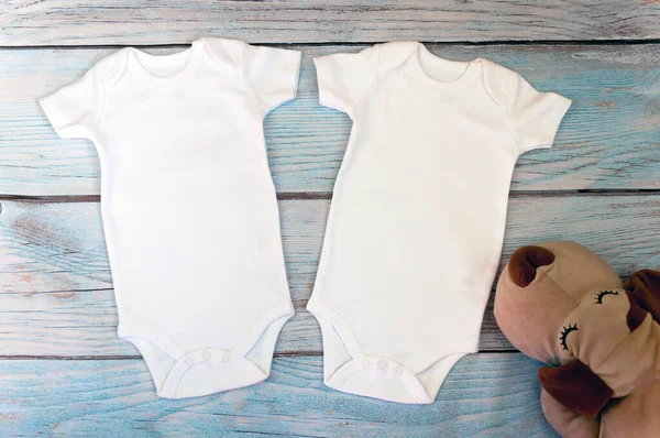 Layout Flat Put Two White Baby Bodysuit Wooden Background Dog — Stock Photo, Image