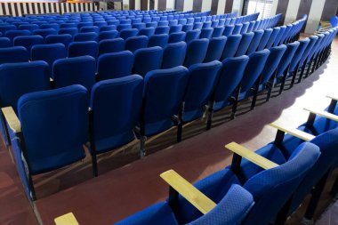 Konferans salonu Kalaburagi, Karnataka, Hindistan-17 Nisan 20.21 'de izole edilmiş mavi renkli sandalyelerin uzun bir görüntüsü