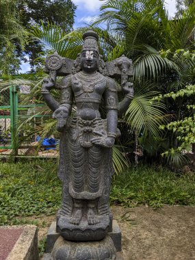 view of Lord Sri Venkateshwara stone idol isolated in Natural rock garden in Tirumala: Tirumala, Andhra Pradesh, India-July 10.2021