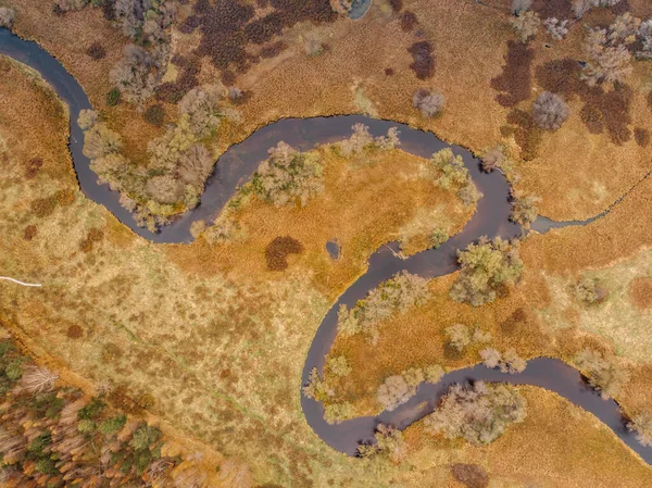 Aerial view of river stream.The river zigzags through the countryside.Meander of Vltava river,Czech republic.Colorful aerial landscape of river coast.Top view drone shot of meadow and water.