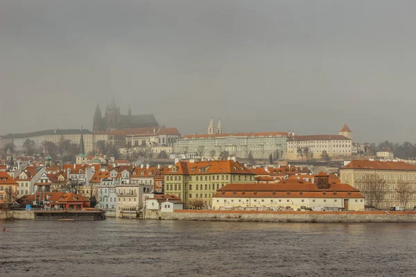 Postcard view of Prague Castle in mist from Charles Bridge,Czech republic.Famous tourist destination.Prague panorama.Foggy morning in city.Amazing European cityscape.Inversion weather outdoors