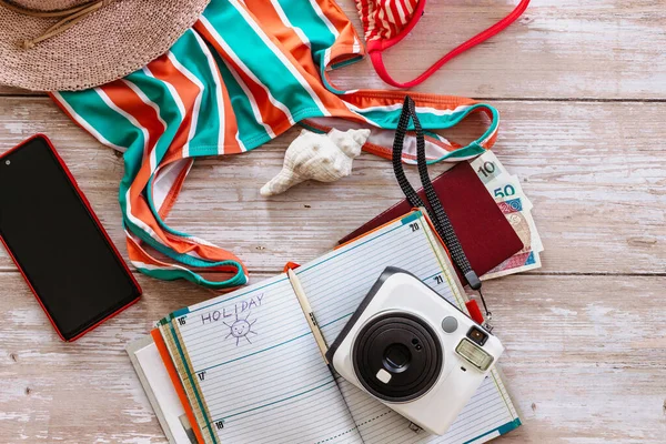 Travel concept banner flat lay.Items for summer vacation: passport,bikini,hat,money,smartphone,camera copy space.Top view holiday concept.Planning Preparation fun trip by sea.Travel accessories.