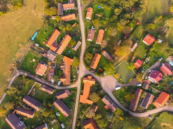 Aerial view of a small village.Top view of traditional housing estate in Czech. Looking straight down with a satellite image style.Houses from above, real estate concept.Country road urban scene