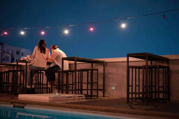 two woman friend relax in night club at terrace  and roof top of restaurant