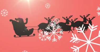 Noel Baba 'nın siyah siluetinin üzerine düşen kar tanelerinin dijital animasyonu ren geyikleri tarafından çekiliyor ve turuncu arka planda parlak bir ışık var. Noel kutlaması geleneği