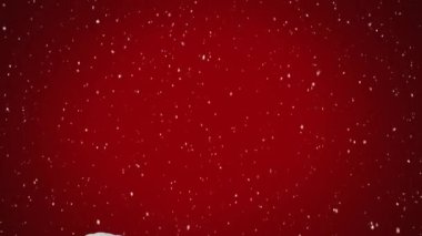 Kış mevsiminde kırmızı arka planda evin üzerine düşen karın dijital animasyonu. Noel kutlaması geleneği