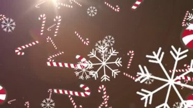 Kahverengi arka plandaki ışık noktalarına düşen çoklu şeker çubukları ve kar tanelerinin dijital animasyonu. Noel kutlaması geleneği