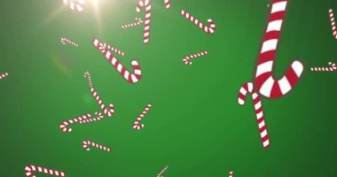 Noel şekerlerinin canlandırılması yeşil arka planda parlayan ışıkla süslenir. Noel kutlaması konsepti dijital olarak oluşturulmuş görüntü.
