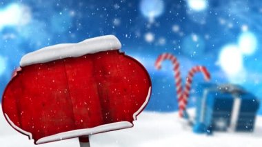 Kırmızı tahta levha direğinin üzerine düşen karların dijital animasyonu Noel hediyesi kutusu ve mavi arka planda şeker kamışı. Noel kutlaması geleneği