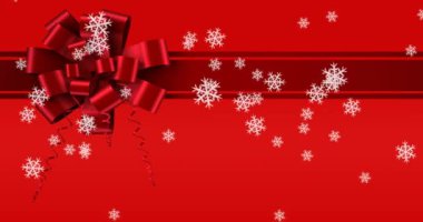 Kırmızı arka planda kurdele yayı üzerine düşen kar tanelerinin dijital animasyonu. Noel kutlaması geleneği