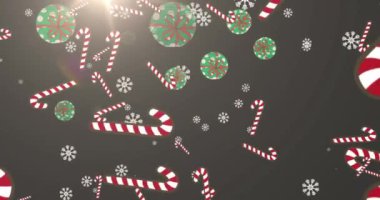 Yılbaşı hediyeleri, baston şekerler ve parlak gri arka planda düşen kar tanelerinin animasyonu. Noel kutlaması konsepti dijital olarak oluşturulmuş görüntü.