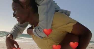 Kırmızı kalp balonlarının erkeğin üzerinde yüzmesi kumsaldaki kadını sırtında taşıyor. Dijital ortamda oluşturulan Sevgililer Günü kutlaması konseptiniz kutlu olsun..