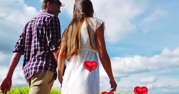 恋人同士が手を取り歩きながら 夫婦の真ん中に浮かぶ赤いハートバルーンのアニメーション ハッピーバレンタインデーのお祝いのコンセプトデジタル生成された画像 — ストック動画