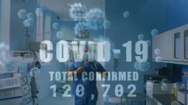 Hastanedeki sağlık personeli üzerinde çovid 19 metin, numara ve cep telefonu animasyonu. küresel covid 19 koronavirüs pandemik sağlık krizi konsepti dijital olarak oluşturulmuş görüntü.