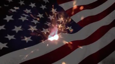 Amerikan bayrağının dalgalanmasına karşı havai fişeklerin yakın plan çekimi. Vatanseverlik yıldızları ve çizgiler konsepti dijital olarak oluşturuldu.